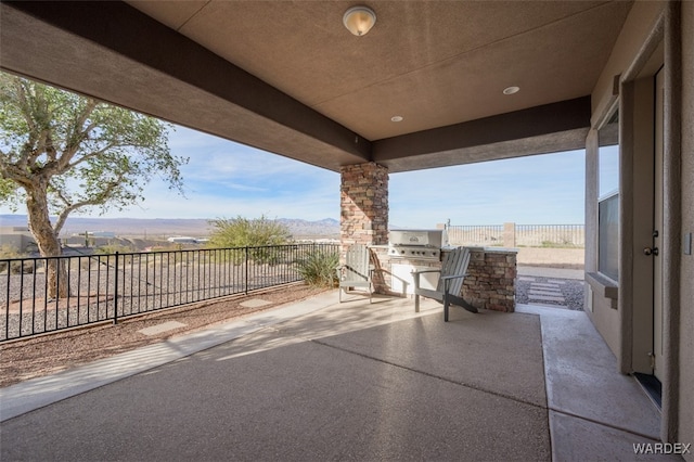 view of patio with fence and area for grilling