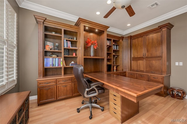 office featuring ornamental molding, visible vents, light wood-style flooring, and a ceiling fan