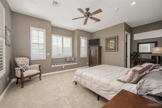 bedroom featuring visible vents, ceiling fan, light carpet, and baseboards