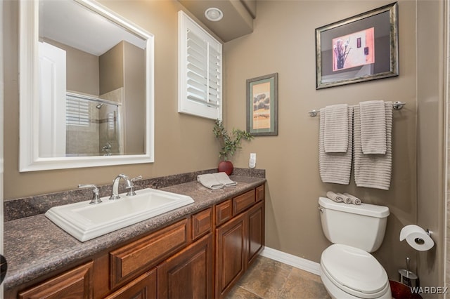 bathroom featuring tiled shower, vanity, toilet, and baseboards