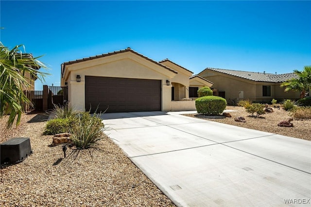 view of front facade featuring driveway, a tile roof, a garage, and stucco siding