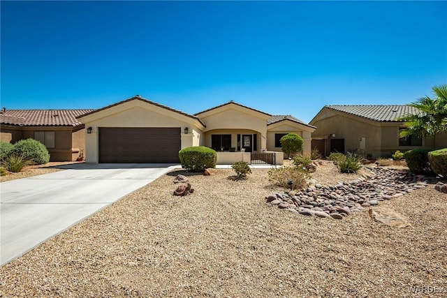 view of front of home with driveway, an attached garage, and stucco siding