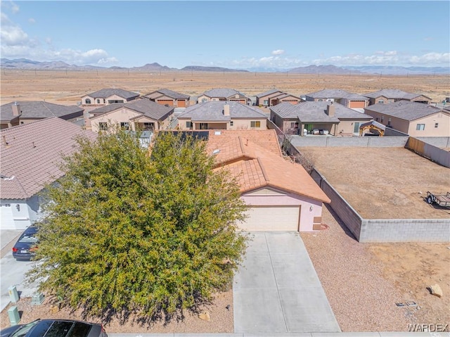 birds eye view of property with a mountain view and a residential view