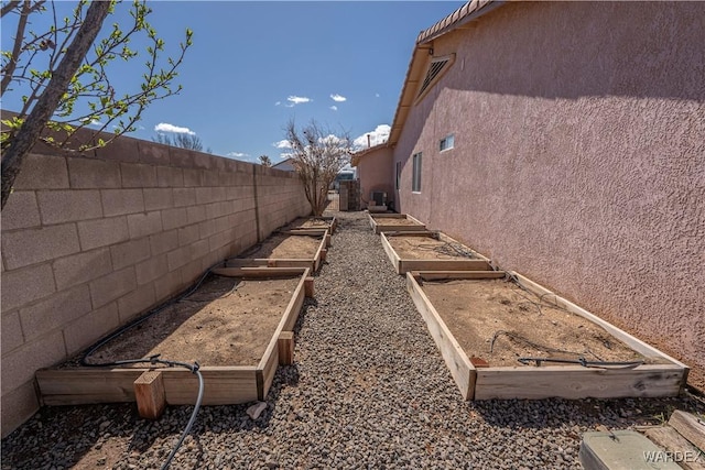 view of yard with a vegetable garden and a fenced backyard