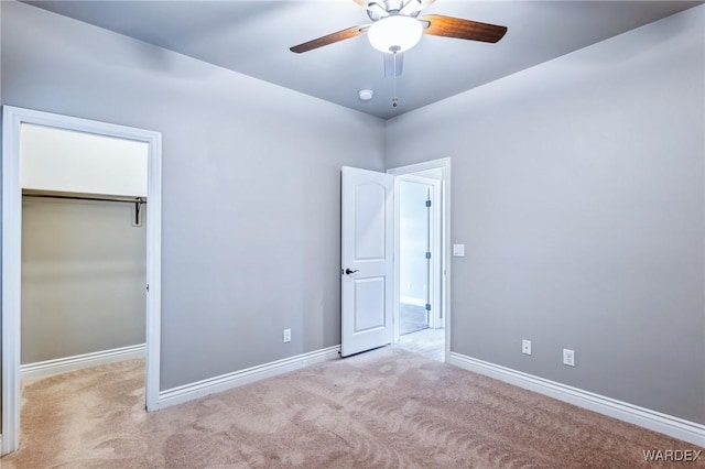 unfurnished bedroom featuring carpet, baseboards, and a closet