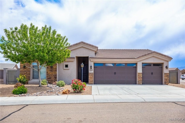view of front of home with stone siding, stucco siding, an attached garage, and driveway