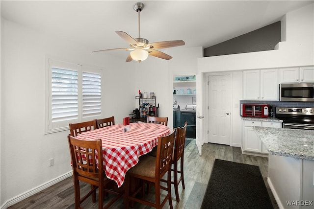 dining room featuring baseboards, lofted ceiling, ceiling fan, dark wood-style flooring, and independent washer and dryer