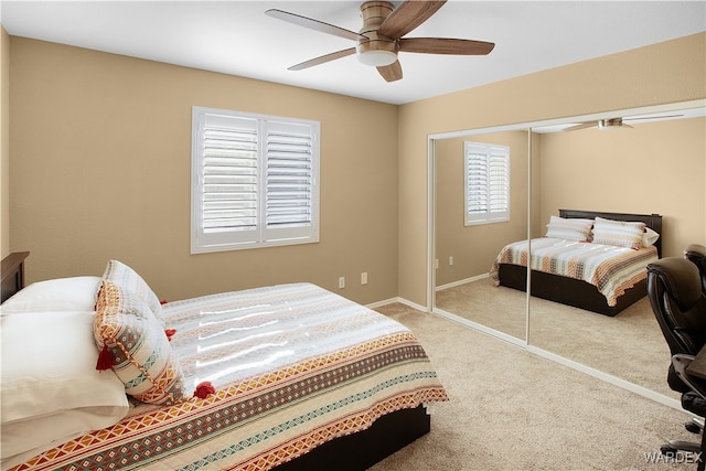 carpeted bedroom featuring ceiling fan, baseboards, and a closet