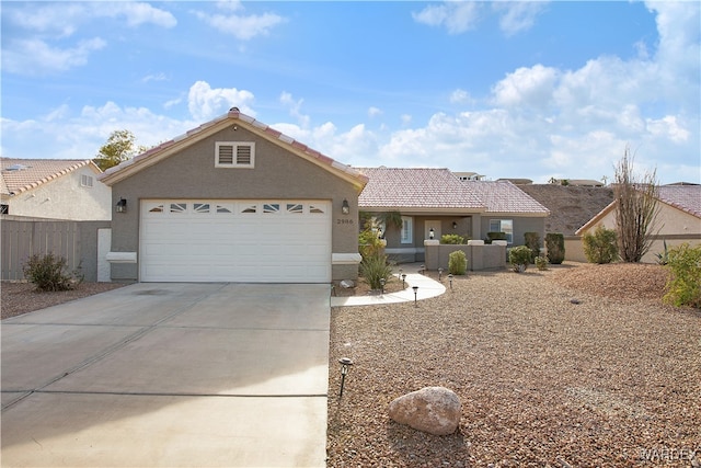 ranch-style house with stucco siding, concrete driveway, an attached garage, fence, and a tiled roof