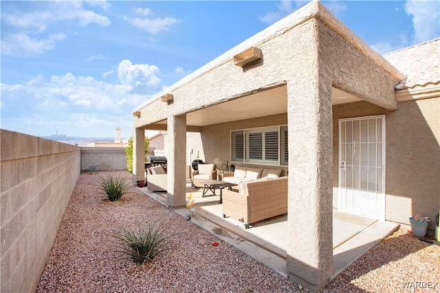 back of house featuring a patio, a fenced backyard, an outdoor living space, and stucco siding