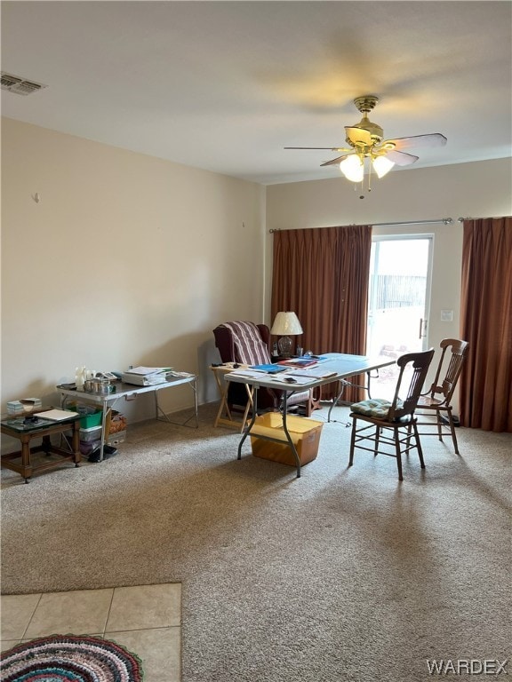 living area with ceiling fan, carpet floors, and visible vents