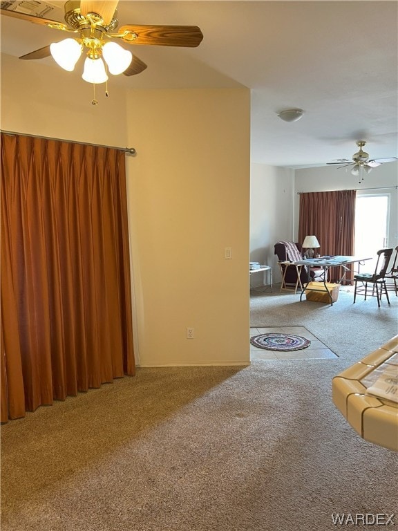 living room featuring carpet and a ceiling fan