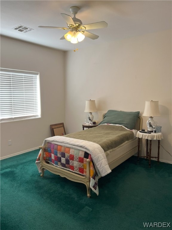 bedroom with a ceiling fan, visible vents, dark carpet, and baseboards