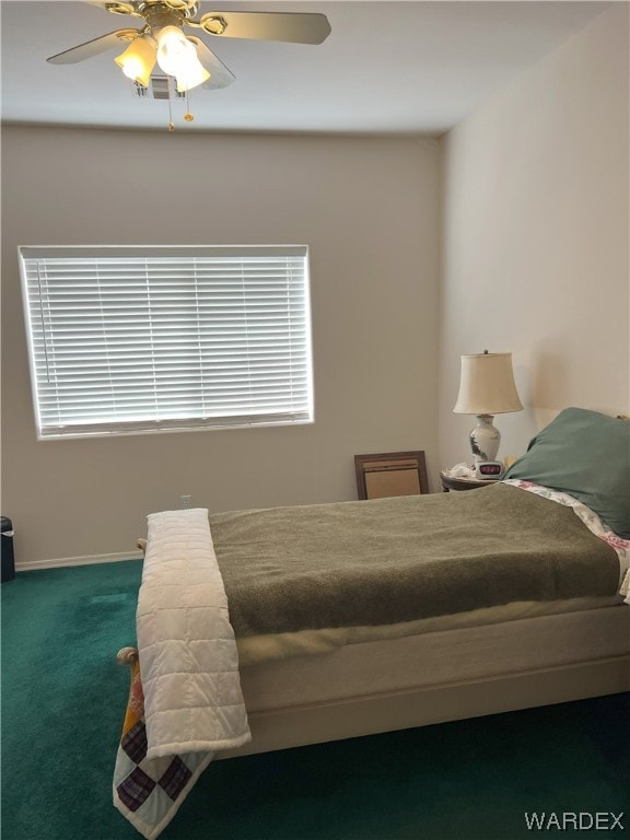 carpeted bedroom with baseboards and a ceiling fan