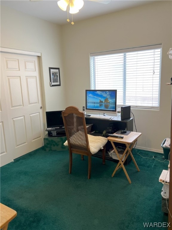 office space featuring ceiling fan and dark colored carpet