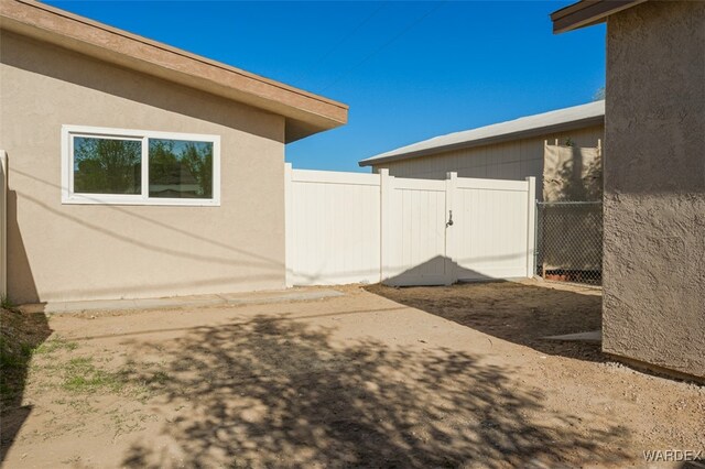 view of yard featuring fence and a gate