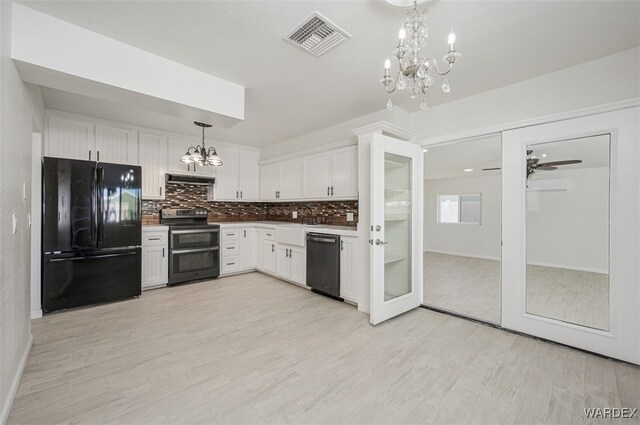 kitchen with visible vents, white cabinetry, hanging light fixtures, appliances with stainless steel finishes, and decorative backsplash