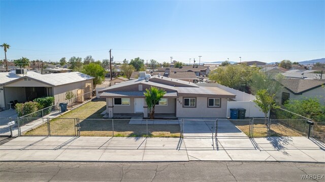 view of front of property featuring a fenced front yard, a residential view, a gate, and stucco siding