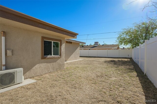 view of yard with ac unit and a fenced backyard