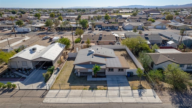 drone / aerial view featuring a residential view and a mountain view