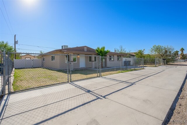 single story home with a front lawn, fence private yard, and a gate