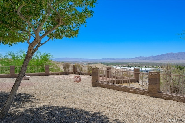 view of yard with fence and a mountain view