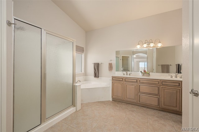 bathroom with a stall shower, vaulted ceiling, a sink, tile patterned flooring, and a bath