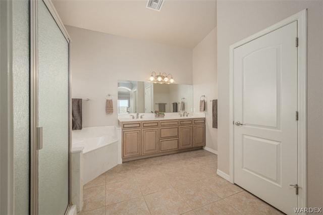 bathroom featuring a garden tub, visible vents, a sink, and tile patterned floors