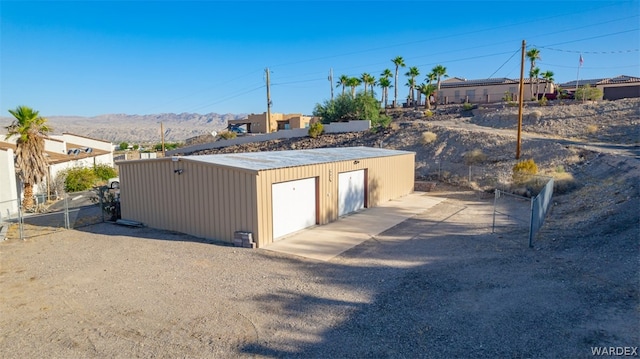 detached garage with fence and a mountain view