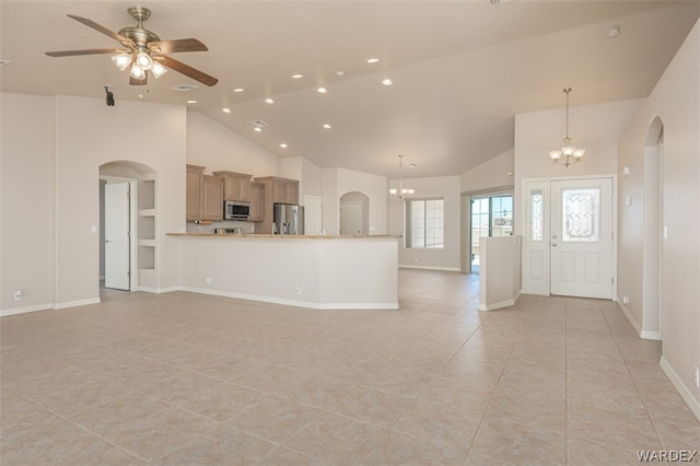 unfurnished living room featuring light tile patterned floors, arched walkways, ceiling fan with notable chandelier, high vaulted ceiling, and recessed lighting