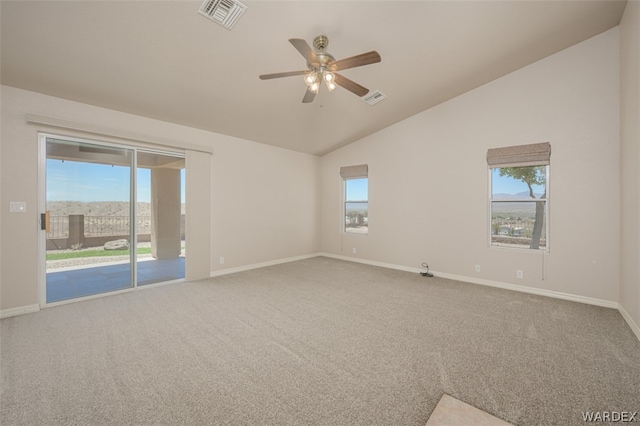 unfurnished room featuring vaulted ceiling, visible vents, and a healthy amount of sunlight