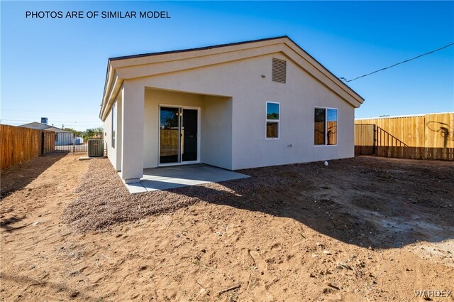 back of property featuring a patio area, a fenced backyard, cooling unit, and stucco siding