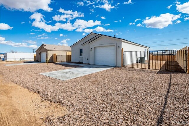 view of front of home with driveway, an attached garage, and fence