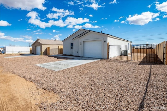 view of home's exterior with an outdoor structure and fence