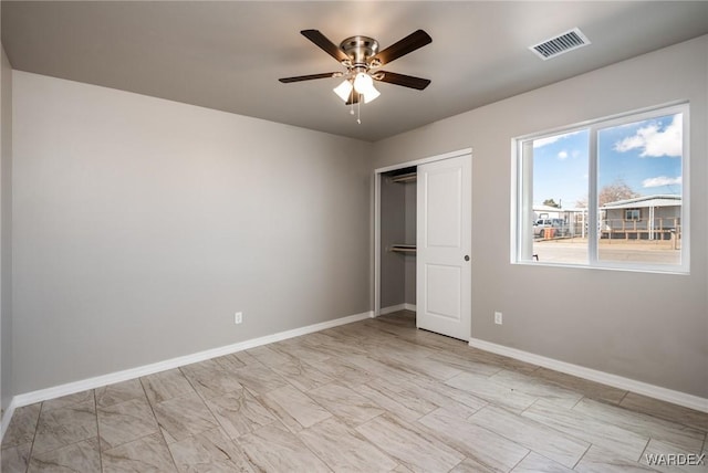 unfurnished bedroom featuring visible vents, baseboards, a closet, and ceiling fan