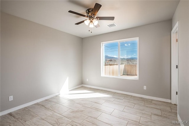 spare room featuring visible vents, baseboards, and ceiling fan