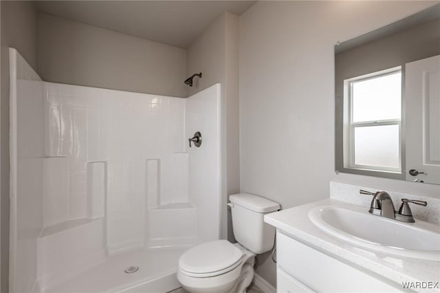 bathroom with vanity, toilet, and walk in shower