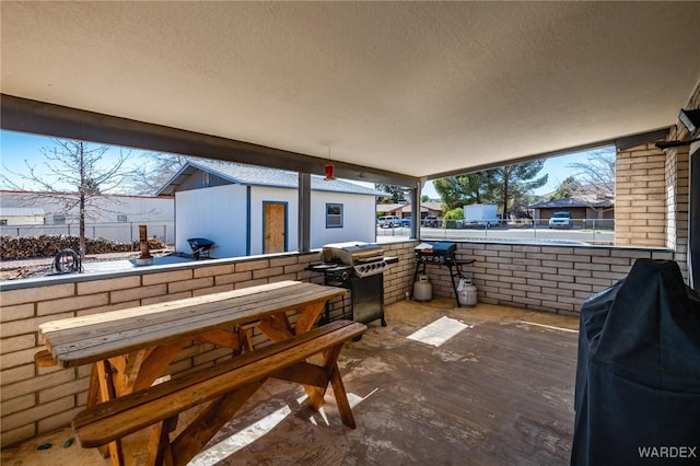 view of patio featuring an outbuilding and area for grilling