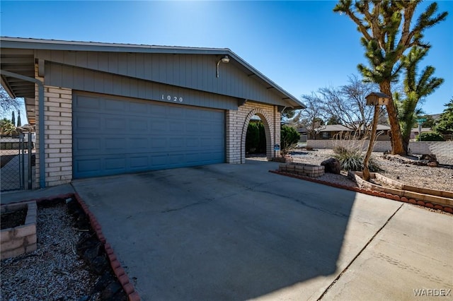 view of front facade with concrete driveway and brick siding