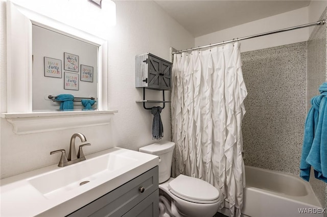 bathroom with toilet, shower / tub combo with curtain, and vanity