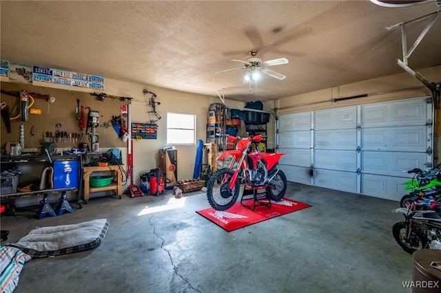 garage with ceiling fan and a workshop area