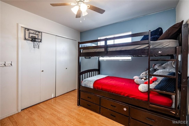 bedroom with a closet, a ceiling fan, and wood finished floors