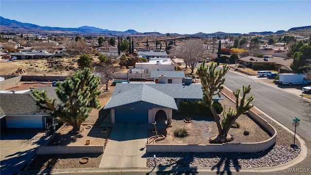 drone / aerial view featuring a residential view and a mountain view