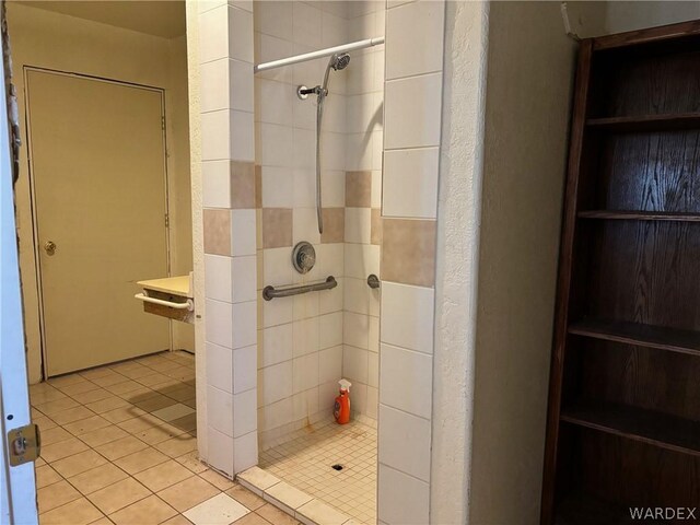 full bathroom featuring a shower stall and tile patterned flooring