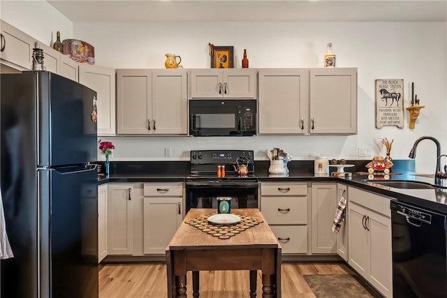 2602 Bear Mountain Loop, Bullhead City, AZ 86442 - kitchen with black appliances, a sink, light wood-style floors, and dark countertops