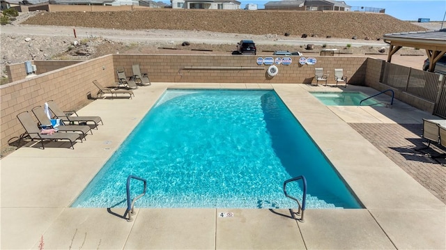 2602 Bear Mountain Loop, Bullhead City, AZ 86442 - community pool with a fenced backyard and a patio area