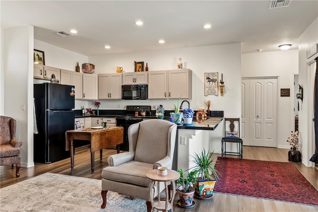 2602 Bear Mountain Loop, Bullhead City, AZ 86442 - kitchen with black appliances, light wood-style floors, dark countertops, and recessed lighting