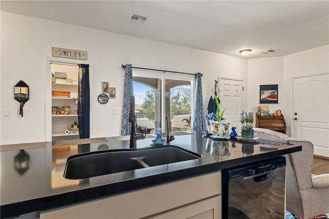 2602 Bear Mountain Loop, Bullhead City, AZ 86442 - kitchen featuring dishwasher, a sink, dark countertops, white cabinets, and wood finished floors