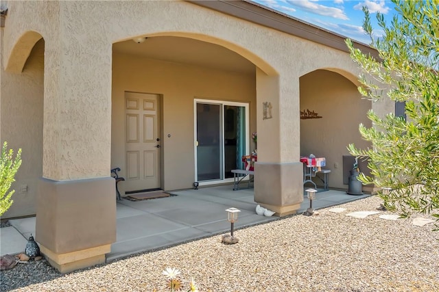 2602 Bear Mountain Loop, Bullhead City, AZ 86442 - view of exterior entry with stucco siding and a patio area