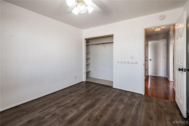 unfurnished bedroom with a closet, baseboards, a ceiling fan, and dark wood-style flooring